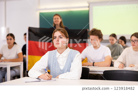 Teacher stands behind students with German flag 123918482