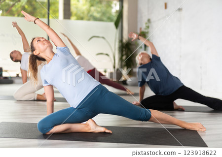 People relaxing and enjoying yoga elements 123918622