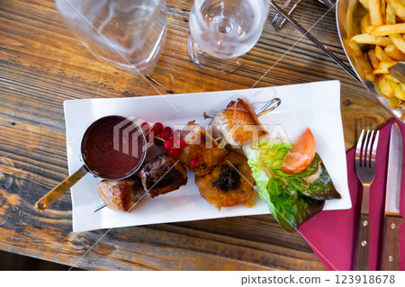 Grilled duck magret skewer with redcurrant sauce and vegetables Grilled duck magret skewer with redcurrant sauce and vegetables 123918678