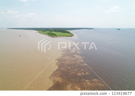 River confluence showing distinct colors in the water at Amazon region River confluence showing distinct colors in the water at Amazon region 123919677