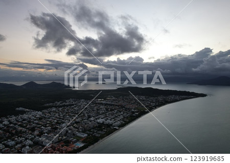 Coastal town facing stormy weather during twilight hours along the shoreline Coastal town facing stormy weather during twilight hours along the shoreline 123919685