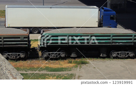 Freight Cars With Gravel Stone Overhead Cargo Truck On A Road Freight Cars With Gravel Stone Overhead Cargo Truck On A Road 123919991