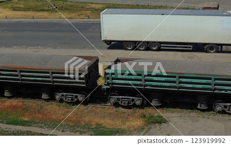 Cargo Train With Crushed Stone Near Truck Car On A Road 123919992