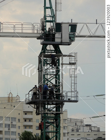 Crane Operators Adjusting Of Construction Tower Crane Crane Operators Adjusting Of Construction Tower Crane 123920003