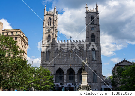 Montreal, Quebec, Canada - August 2 2021 : Notre-Dame Basilica of Montreal and Maisonneuve Monument in Old Montreal Place d'Armes. 123921059