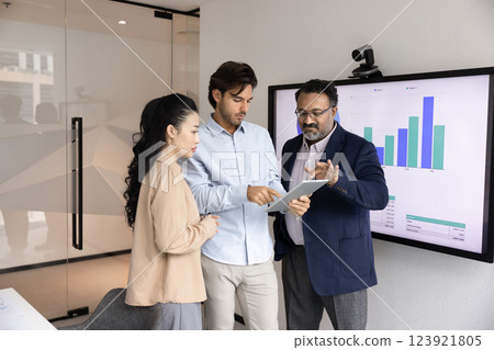 Multiethnic team of business colleagues using tablet in meeting room Multiethnic team of business colleagues using tablet in meeting room 123921805