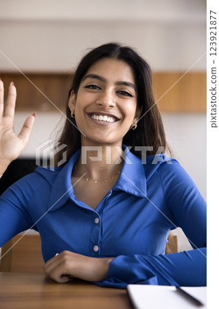 Indian woman waving, start videocall, streaming or recording video 123921877
