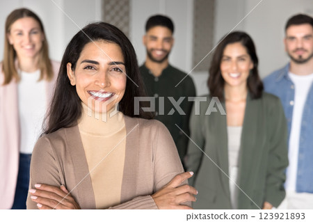 Beautiful Brazilian woman posing with corporate staff in office Beautiful Brazilian woman posing with corporate staff in office 123921893