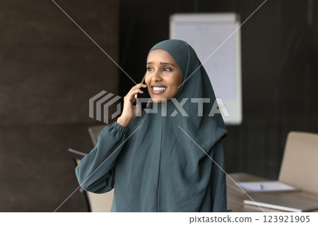 Arabian businesswoman dressed in hijab lead formal talk on smartphone Arabian businesswoman dressed in hijab lead formal talk on smartphone 123921905