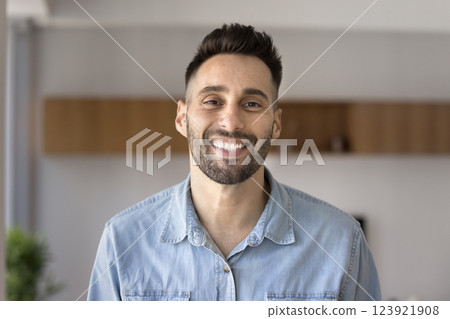 Head shot portrait young Hispanic man smile staring at camera Head shot portrait young Hispanic man smile staring at camera 123921908
