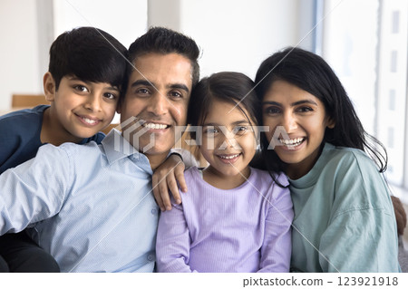 Closeup of beautiful overjoyed Indian couple with two little kids 123921918