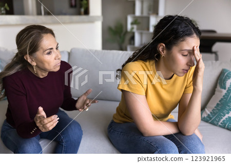 Elderly woman scolding, screaming at grown up 20s daughter Elderly woman scolding, screaming at grown up 20s daughter 123921965