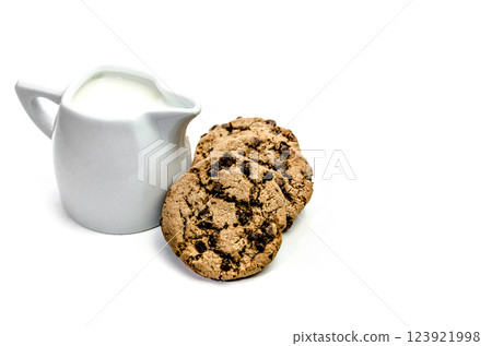 Close-up of homemade chocolate chip cookies with a jug of milk isolated on white background. 123921998