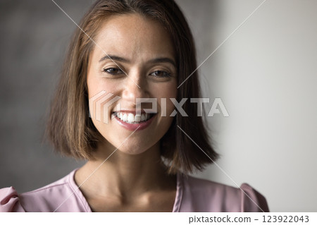 Pretty woman with warm and friendly smile looking at camera 123922043