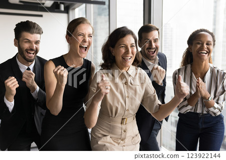 Group of businesspeople celebrating achievement, looks enthusiastic and joyful 123922144