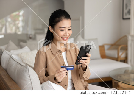 Happy beautiful Asian girl shopping with credit card Happy beautiful Asian girl shopping with credit card 123922165