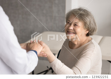 Happy older age grandmother patient give hand to trusted doctor 123922231