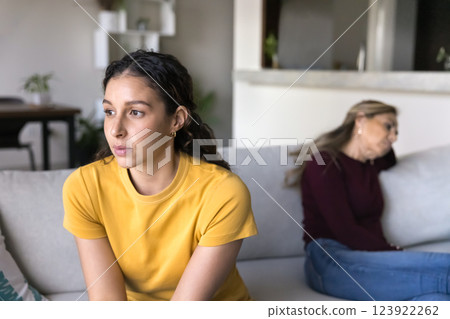Young 25s woman sitting on sofa apart from older mother 123922262