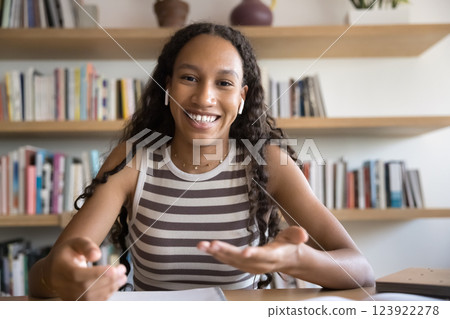 Webcam view African girl wear earphones speaking, looking at camera Webcam view African girl wear earphones speaking, looking at camera 123922278