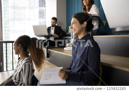 Diverse groupmates take part in educational class seated in auditorium Diverse groupmates take part in educational class seated in auditorium 123922285