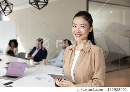 Happy beautiful young Asian project leader woman posing for portrait 123922401