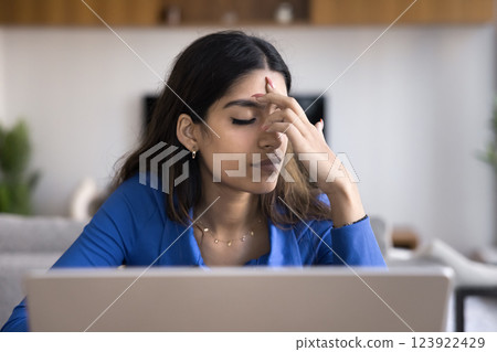 Woman sit with laptop with eyes closed and memorize information Woman sit with laptop with eyes closed and memorize information 123922429