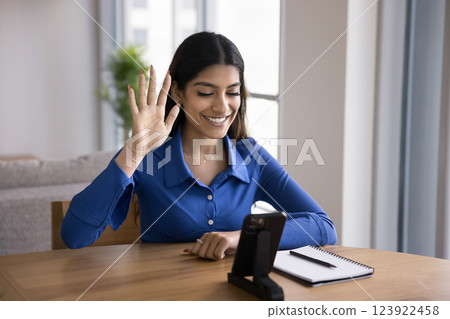 Woman greeting tutor or friend while look at cellphone screen Woman greeting tutor or friend while look at cellphone screen 123922458