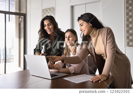 Three multiethnic women colleagues using laptop collaborate on joint task Three multiethnic women colleagues using laptop collaborate on joint task 123922501