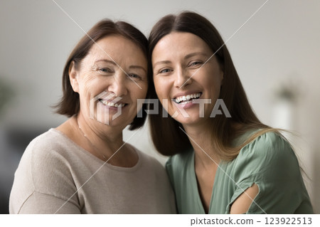 Two beautiful older and younger women posing for camera 123922513