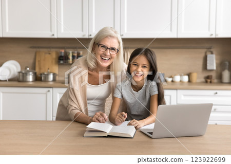 Mature granny tween age girl finished doing assignment at kitchen 123922699