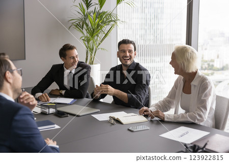 Joyful corporate business team laughing having fun at conference table 123922815
