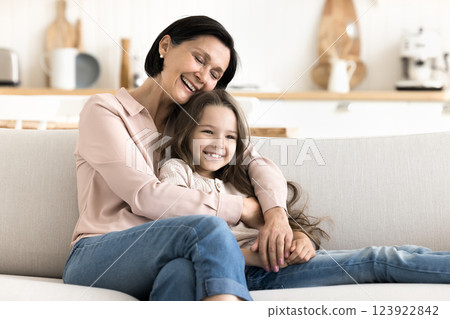 Affectionate aged grandmother hug hold in arms cute little granddaughter 123922842