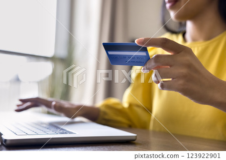 Woman using laptop, enter debit card details for payment, closeup 123922901