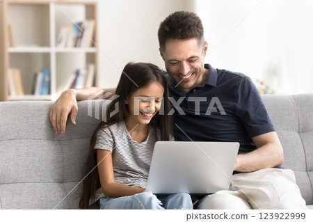 Happy single parent dad tween age daughter enjoy using laptop Happy single parent dad tween age daughter enjoy using laptop 123922999