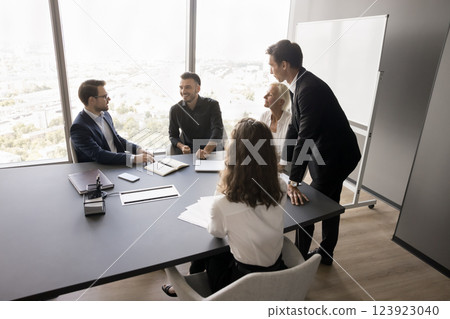 Confident coach group of employees gather at boardroom for brainstorming 123923040