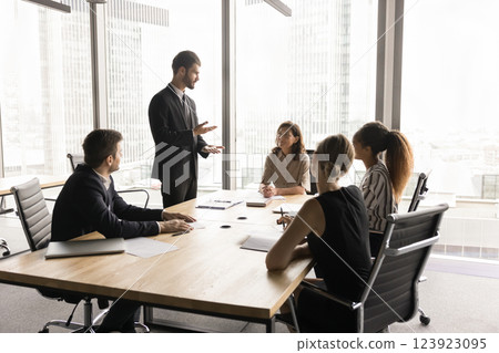 Millennial European businessman in suit lead formal meeting Millennial European businessman in suit lead formal meeting 123923095