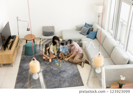 Parents and kids playing with colorful building blocks, top view 123923099