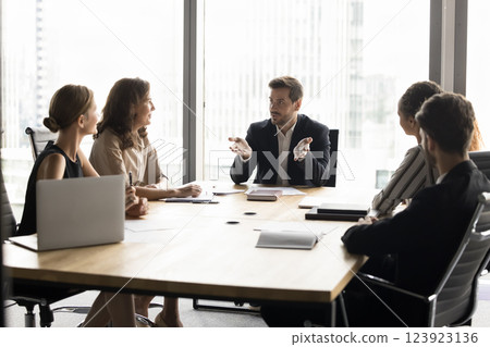 Stakeholders engaged in corporate meeting in modern high-rise office building 123923136