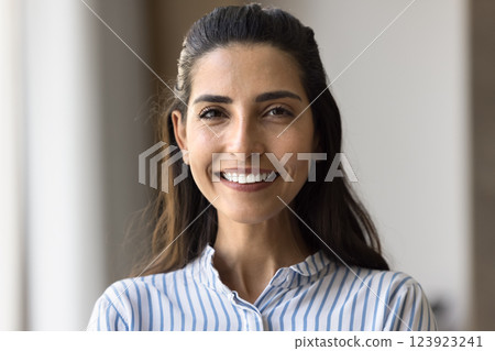 Head shot portrait of beautiful smiling Brazilian woman posing indoors Head shot portrait of beautiful smiling Brazilian woman posing indoors 123923241