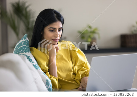 Indian woman watching educational or informative content on laptop 123923268