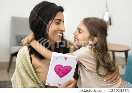 Little daughter congratulate mother on holiday, close up 123923273