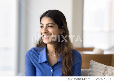 Indian woman relaxing on comfortable sofa in modern living room 123923287