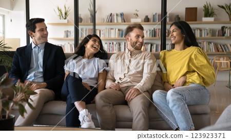 Happy diverse multiethnic students group relax on couch at library Happy diverse multiethnic students group relax on couch at library 123923371