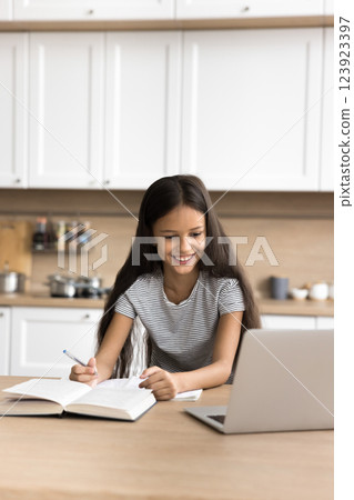 Attentive little pupil girl use pc to study at home 123923397