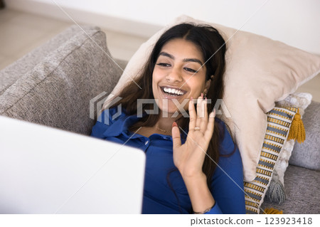 Indian woman starting video call with family using laptop 123923418