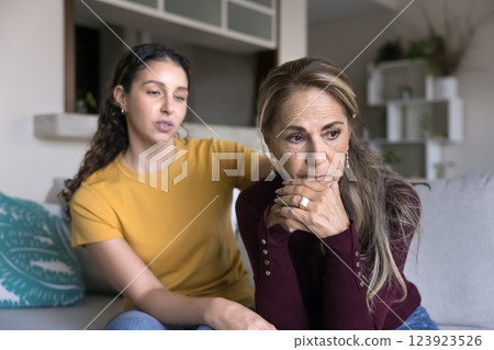 Loving grownup daughter calming, comforting elderly mother Loving grownup daughter calming, comforting elderly mother 123923526