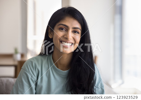 Head shot portrait of beautiful Indian female posing for camera 123923529