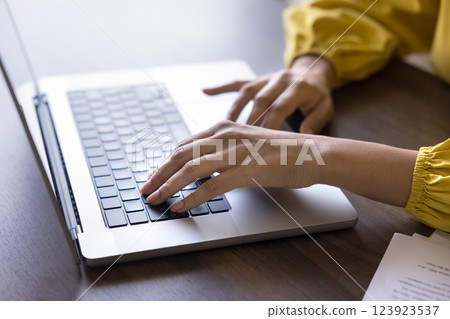 Woman working remotely using laptop, close up shot Woman working remotely using laptop, close up shot 123923537