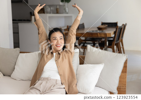 Cheerful beautiful awaking young Asian woman enjoying calm leisure time Cheerful beautiful awaking young Asian woman enjoying calm leisure time 123923554