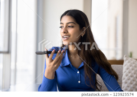 Pretty Indian woman lead personal talk on speakerphone 123923574